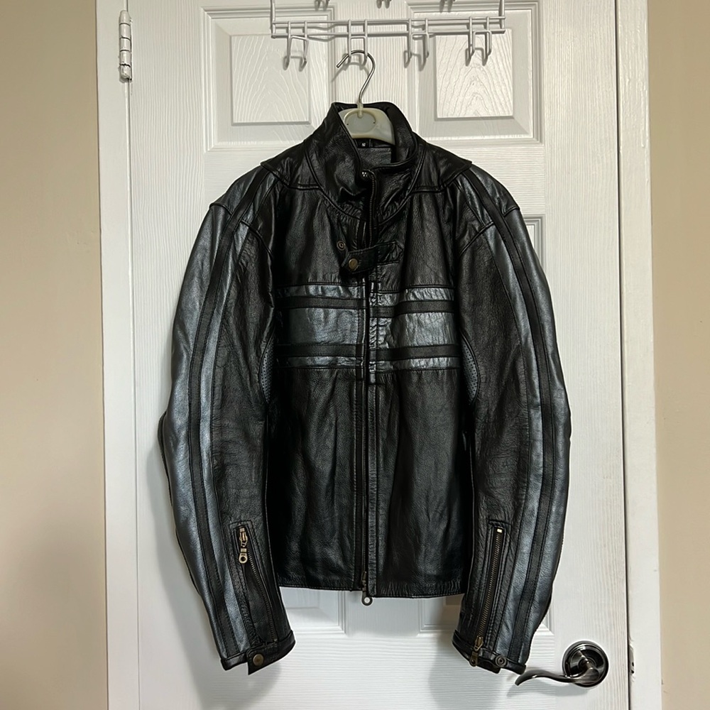 Leather motorcycle jacket with liner and elbow/back inserts for protection.